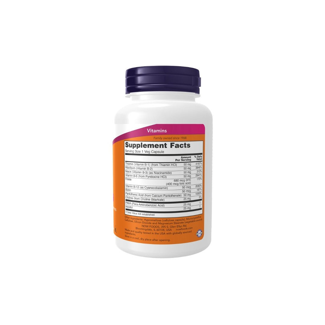 A white Now Foods Vitamin B-50 mg 100 Veg Capsules bottle displaying a B vitamin complex nutrition facts label on an orange background.