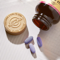 Thumbnail for A brown bottle of Solgar Female Multiple 60 Tablets rests open on a surface beside its cap, with three purple tablets spilled out.