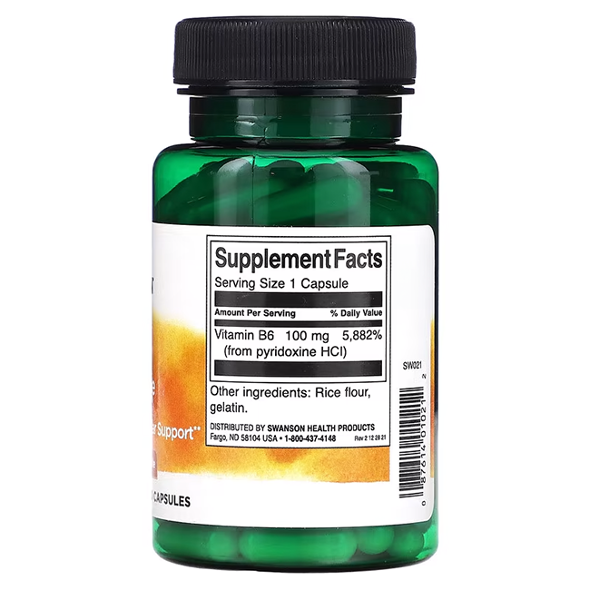 A green bottle of Swanson's Vitamin B6 Pyridoxine 100 mg capsules features a label detailing supplement facts, highlighting Vitamin B6 content and other ingredients like rice flour and gelatin, all designed to support energy metabolism.