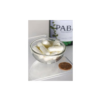 Vorschaubild für Eine Schale Swanson PABA - 500 mg 120 Kapseln neben einer Flasche Wein, die durch ihre antioxidativen Prozesse die Hautgesundheit fördern und bei der Bildung roter Blutkörperchen helfen.