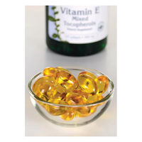 Thumbnail for A small glass bowl contains yellow gel capsules, while a Swanson Vitamin E - 400 IU 100 softgel Mixed Tocopherols bottle is blurry in the background, promoting antioxidant support for cardiovascular health.