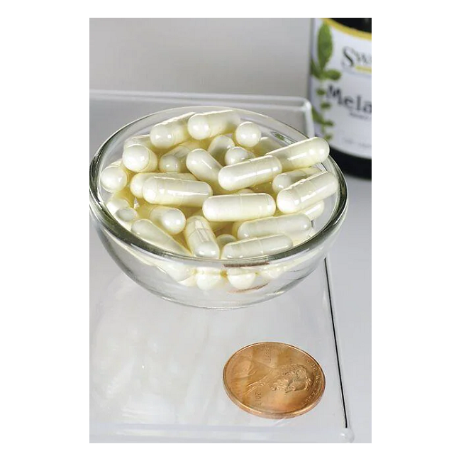 A small glass bowl with white capsules sits beside a penny for scale. Behind it, a bottle labeled "Swanson Melatonin 3 mg 120 Capsules" suggests these sleep hormone supplements could help you conquer jet lag.