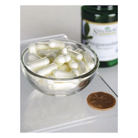 Thumbnail for A small glass bowl filled with Swanson Pregnenolone 10 mg capsules sits beside a brown coin and a partially visible green bottle on a white surface.