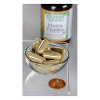 Thumbnail for A small glass bowl with beige capsules sits beside a penny, suggesting the potent benefits of Swanson's Muira Puama - 10:1 Root Extract for sexual health. A blurred bottle labeled 