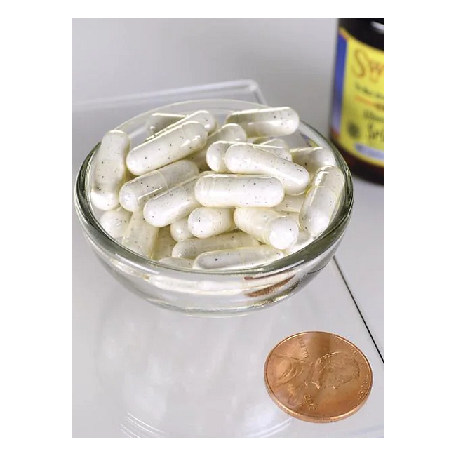 A glass bowl with white capsules, crafted for immune support, sits beside a penny for size comparison. In the background stands a bottle labeled "Swanson Albion Selenium Complex 200 mcg 90 Capsules.