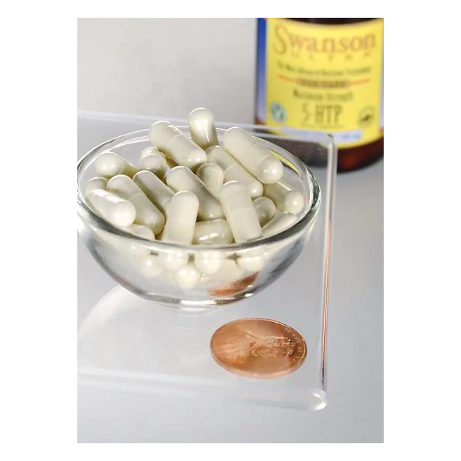 A clear bowl with white capsules of Swanson's 5-HTP (Hydroxytryptophan) 200 mg, Maximum Strength, is placed beside a penny for scale. A blurred "Swanson" bottle in the background suggests its serotonin-enhancing properties.