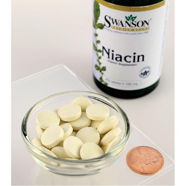 A bottle of Swanson's Vitamin B-3 Niacin - 100 mg 250 tabs, a B-vitamin essential for heart health and carbohydrate metabolism, sits next to a bowl.
