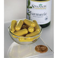 Thumbnail for A bowl of Swanson turmeric capsules - 720 mg 30 capsules, providing antioxidant support and promoting joint health, on a table next to a penny.