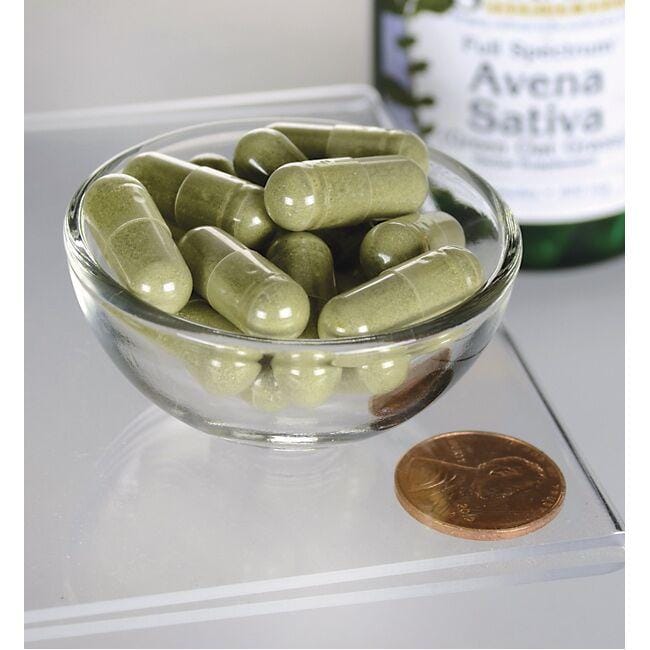 Eine Schale mit Swanson Avena Sativa - 400 mg 60 Kapseln neben einer Flasche Olivenöl.