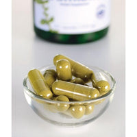 Vorschaubild für Swanson Damiana - 510 mg 100 Kapseln in einer Schale neben einer Flasche Thymian.
