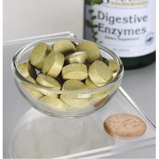 A bowl of Swanson Digestive Enzymes 90 Tablets for carbohydrates, proteins, and fats digestion with a penny for scale.