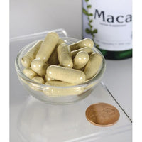 Vorschaubild für Swanson Maca - 500 mg 100 Kapseln in einer Schale neben einer Flasche Swanson Maca.