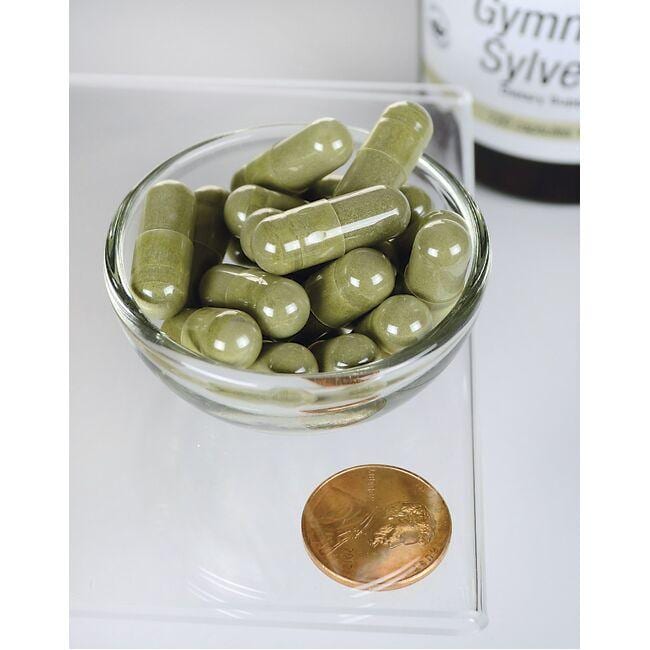 Eine Schale mit Swanson Gymnema Sylvestre Extract - 300 mg 120 Kapseln neben einer Münze.
