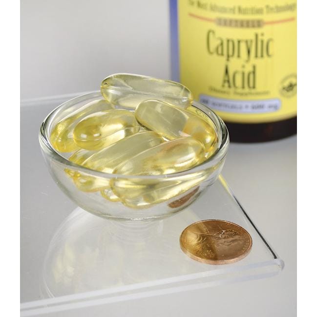 SwansonCaprylsäure - 600 mg 60 Weichkapseln zur Nahrungsergänzung in einer Schale neben einer Münze.