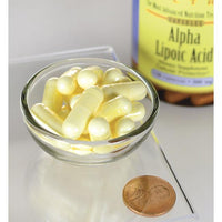 Vorschaubild für Eine Flasche Swanson Alpha-Liponsäure - 300 mg 120 Kapseln steht neben einem Pfennig.